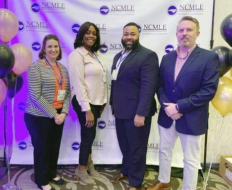 group of people standing at conference