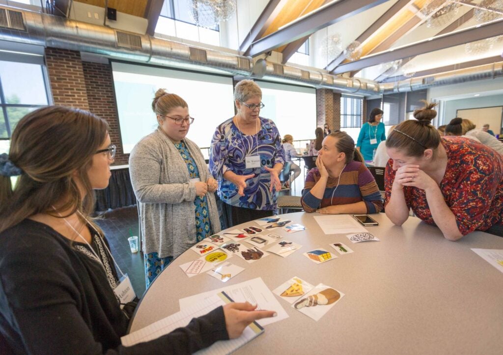 Project CONVEY principal investigator Dr. Sandra Warren, center, speaks with graduate students, from left, Ashton Boyarsky, Allison Skinner, and Samantha Ruppe Beard, who are part of the project’s first cohort during the CONVEY summer institute on Tuesday, June 19. 