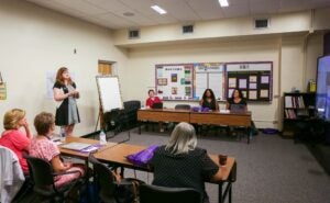 Christine Wilson, ECU College of Education Lead Mursion Coordinator, teaches the school district representatives about Mursion. 