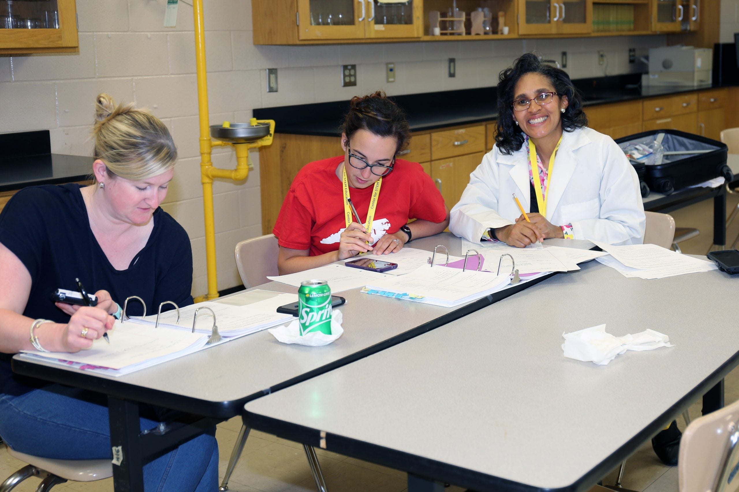 Three AP Chemistry students work on tests