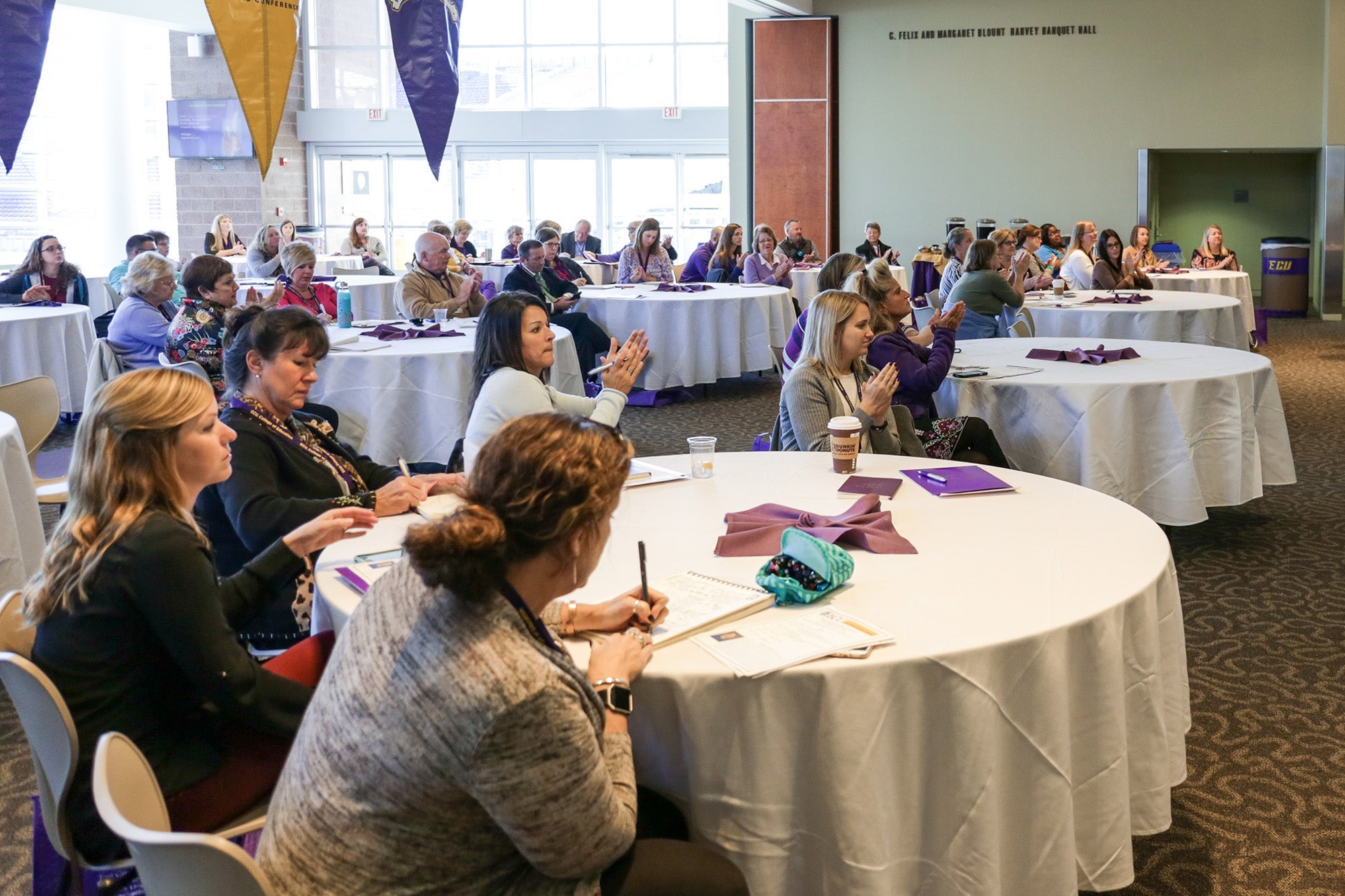 Clinical teacher partners gathered to hear Lisa Godwin speak applaud following her presentation Monday, Oct. 30, at the Murphy Center. 