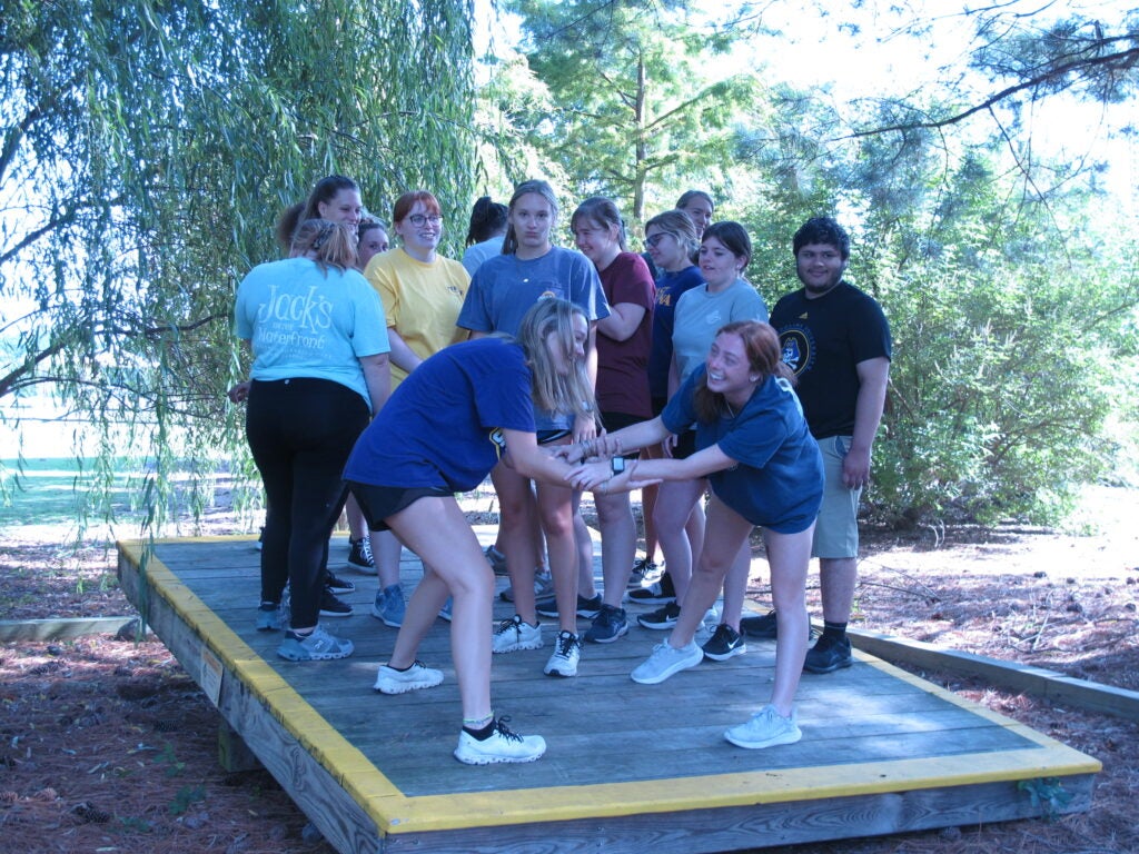 students participate in balancing team work game