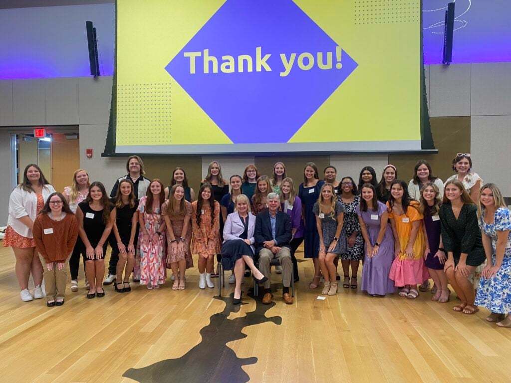 students gathered around Maynards under Thank You graphic