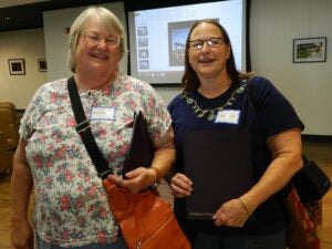 Two Library Science alumni catching up before the event