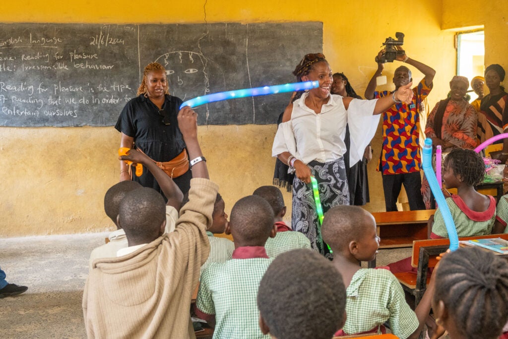 Crumb and Avent Harris stand in front of school classroom