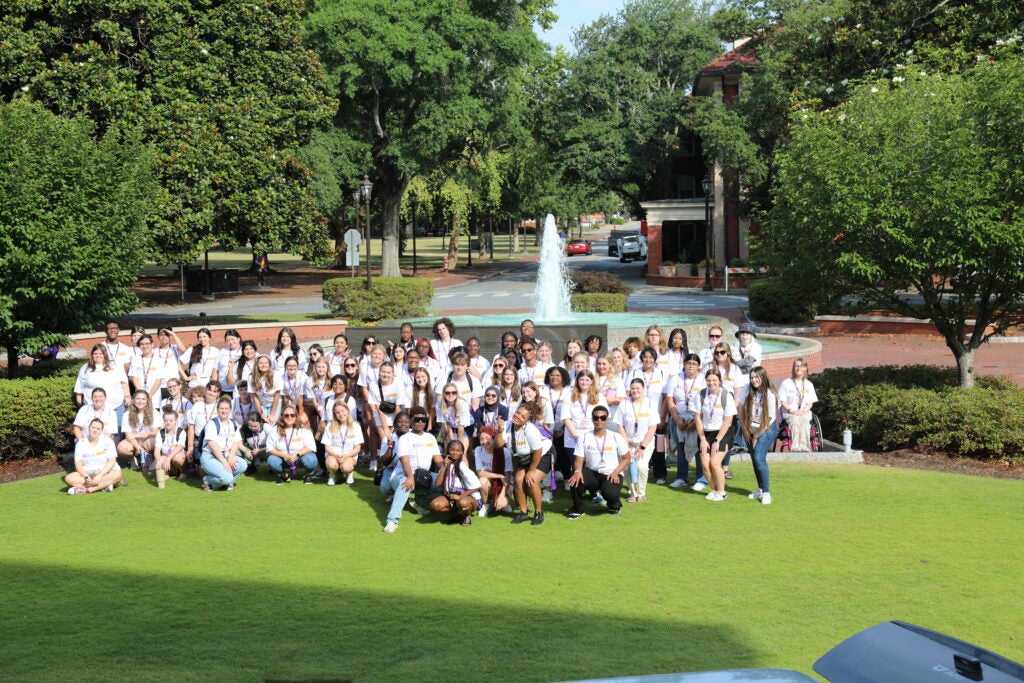 PIRATE participants take a group photo in front of the fountain