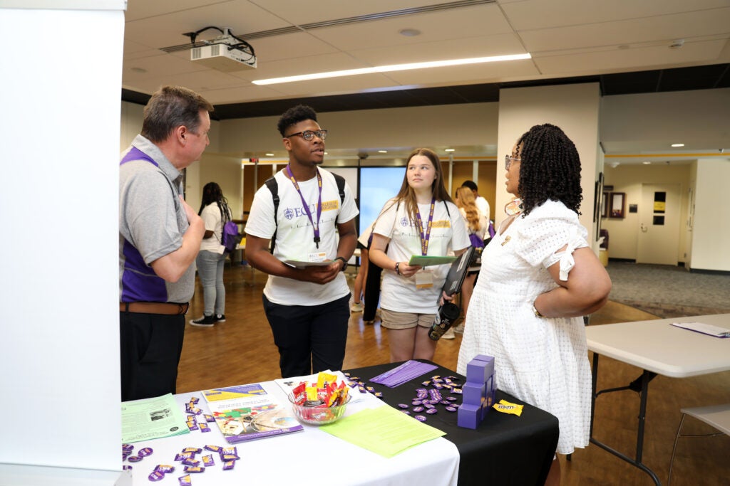 Two PIRATE participants speak to faculty members in math and science education