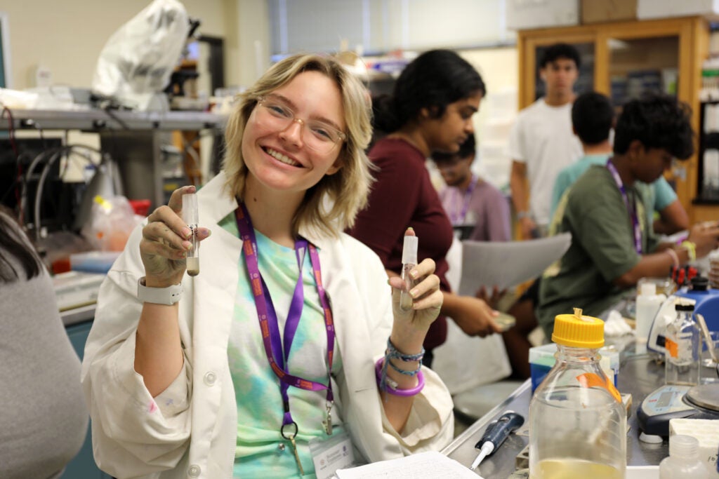 Maddie Woodhouse holding test tubes