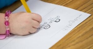 A kindergartner works on a writing assignment at Snow Hill Primary.