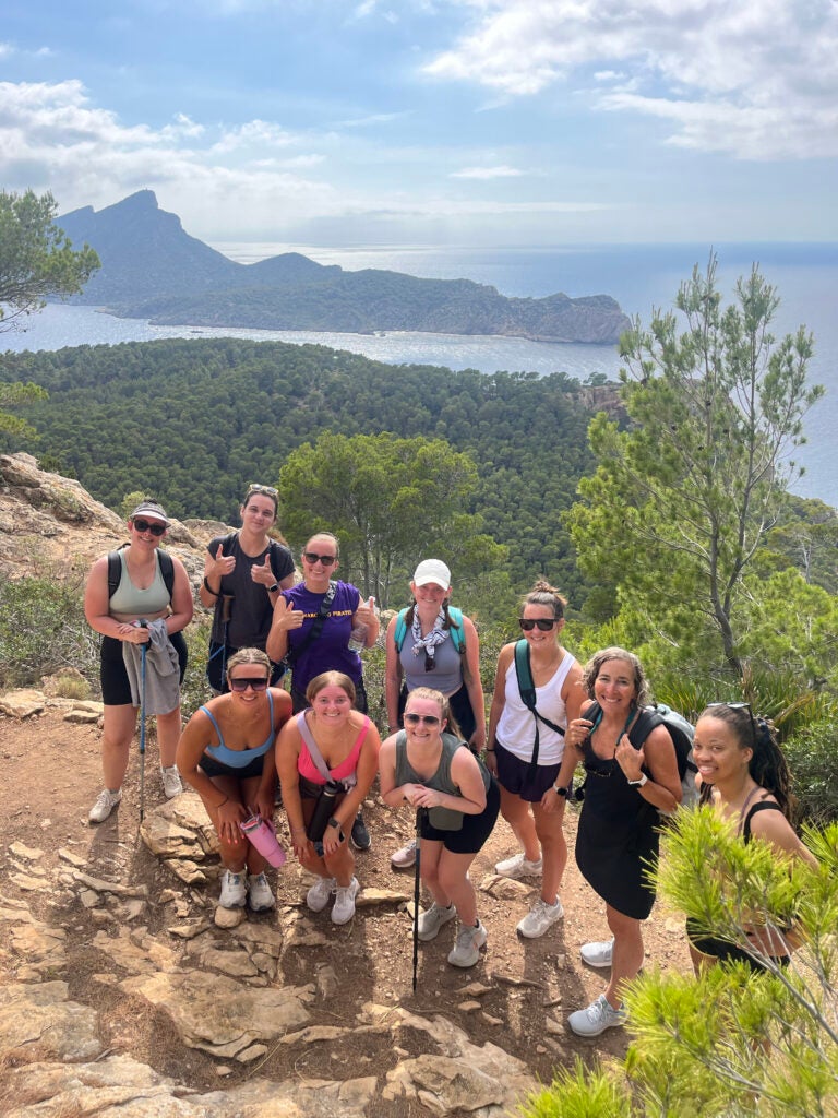 Group of students standing at a cliffside during a hike