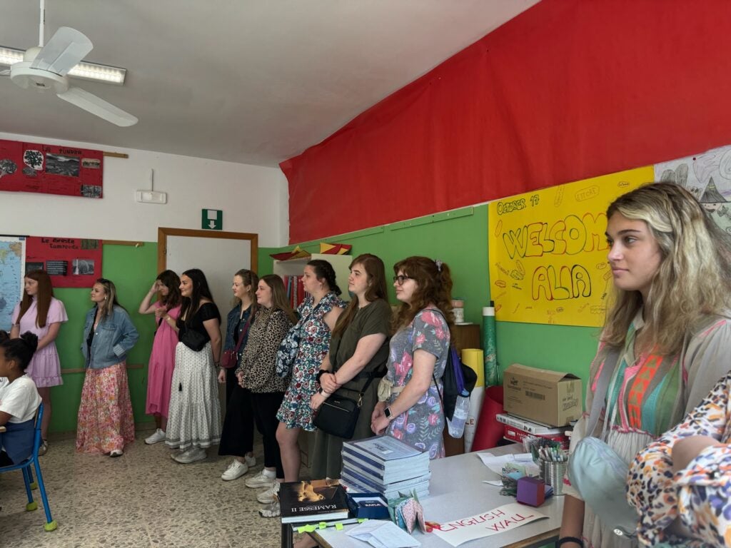 Students stand in back of Italian classroom