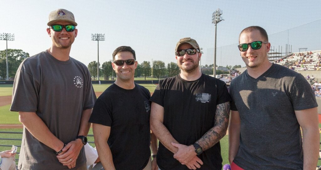 Members of the College of Education Student Veteran Resource Alliance stand with SVRA co-chair Clay Smith, far left, at the ECU Baseball game on Friday, May 11.