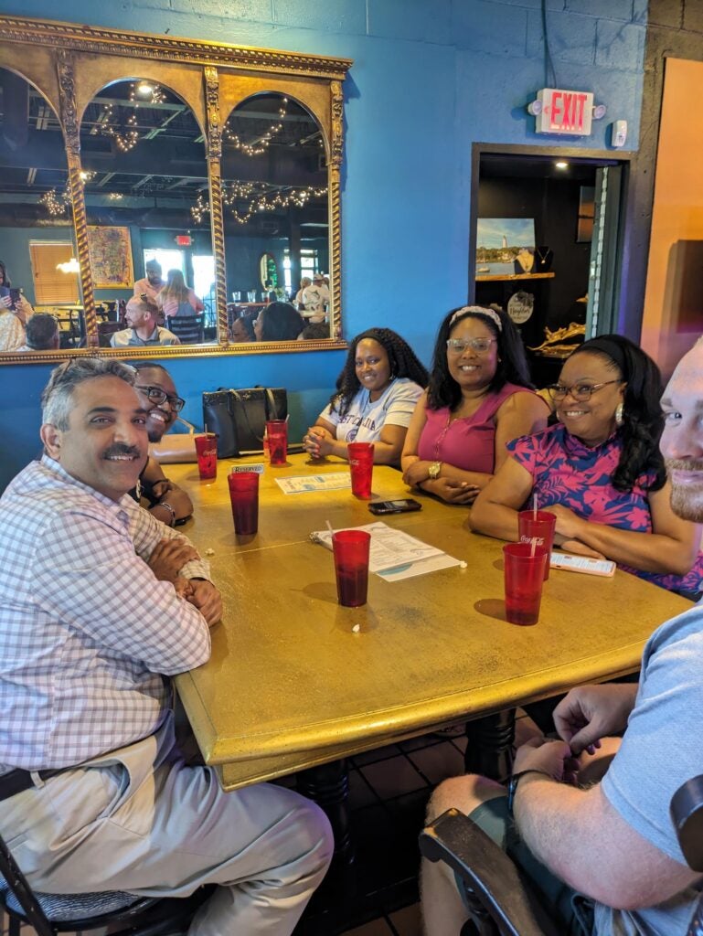 Educational Leadership doctoral students sitting at a table during their June writing retreat