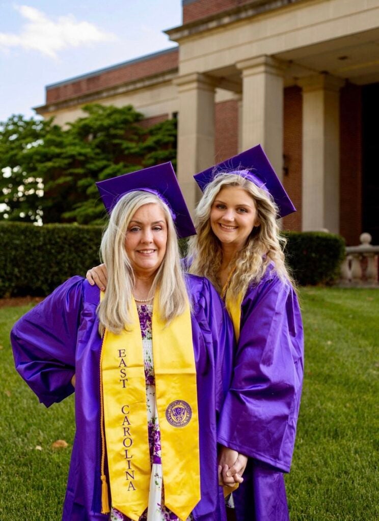 Laura Lee and Mickayla Lee Willobee posing in their caps and gowns