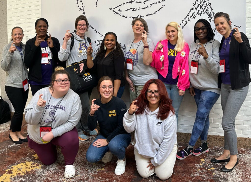 Students pose for a photo throwing up Pirate hooks