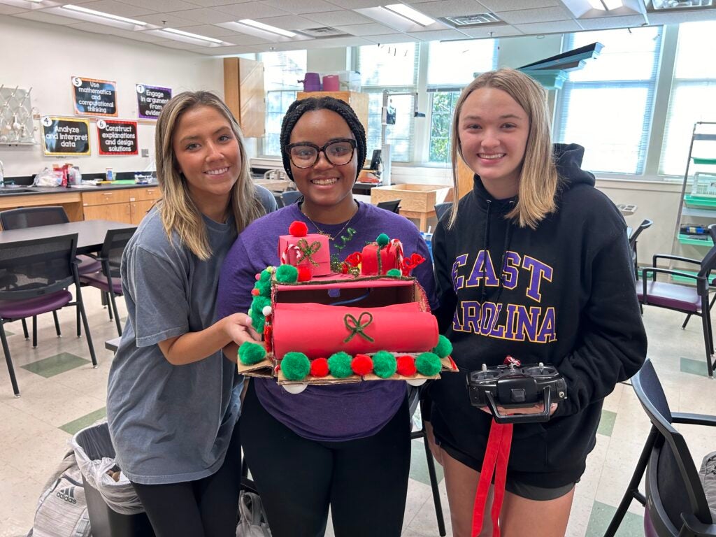 Three education students hold a RoboxSumo 