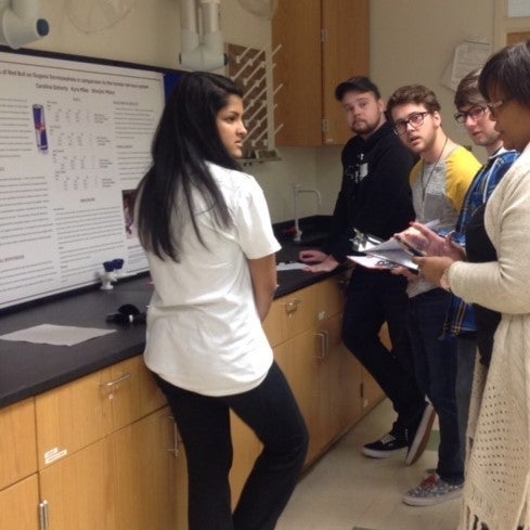 Pitt County High School student Shinjini Misra receives feedback on her project from ECU student judges.