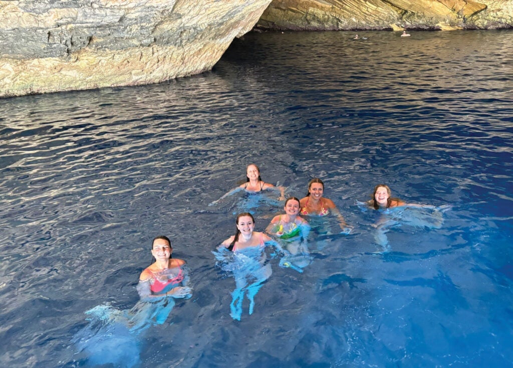 Students swimming in the blue cave