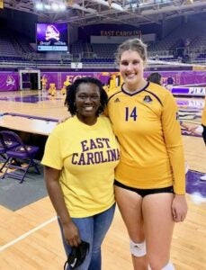 Tomegia Winston and Amelia Davis at an ECU Volleyball game