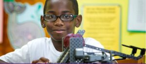 Tyrrek Grizzle poses with a robot he constructed during the robotics summer camp. The camp is part of an ECU partnership that supports elemementary and middle grades students from military families in eastern North Carolina. (Photos by Jay Clark)