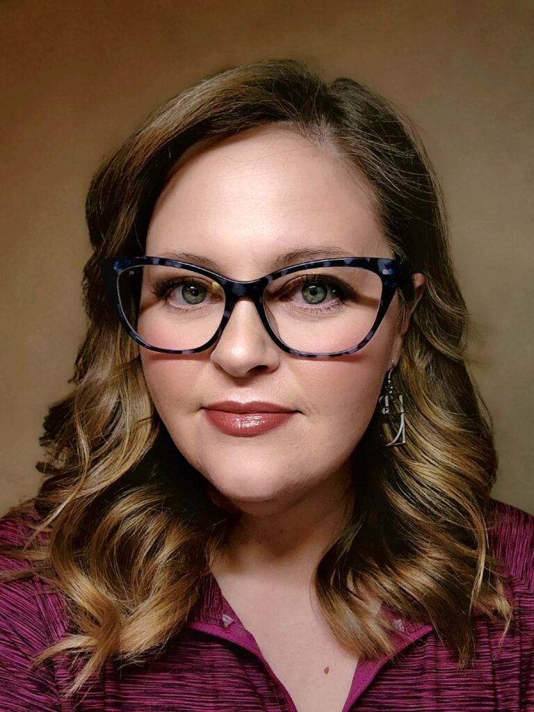 headshot of a woman wearing glasses
