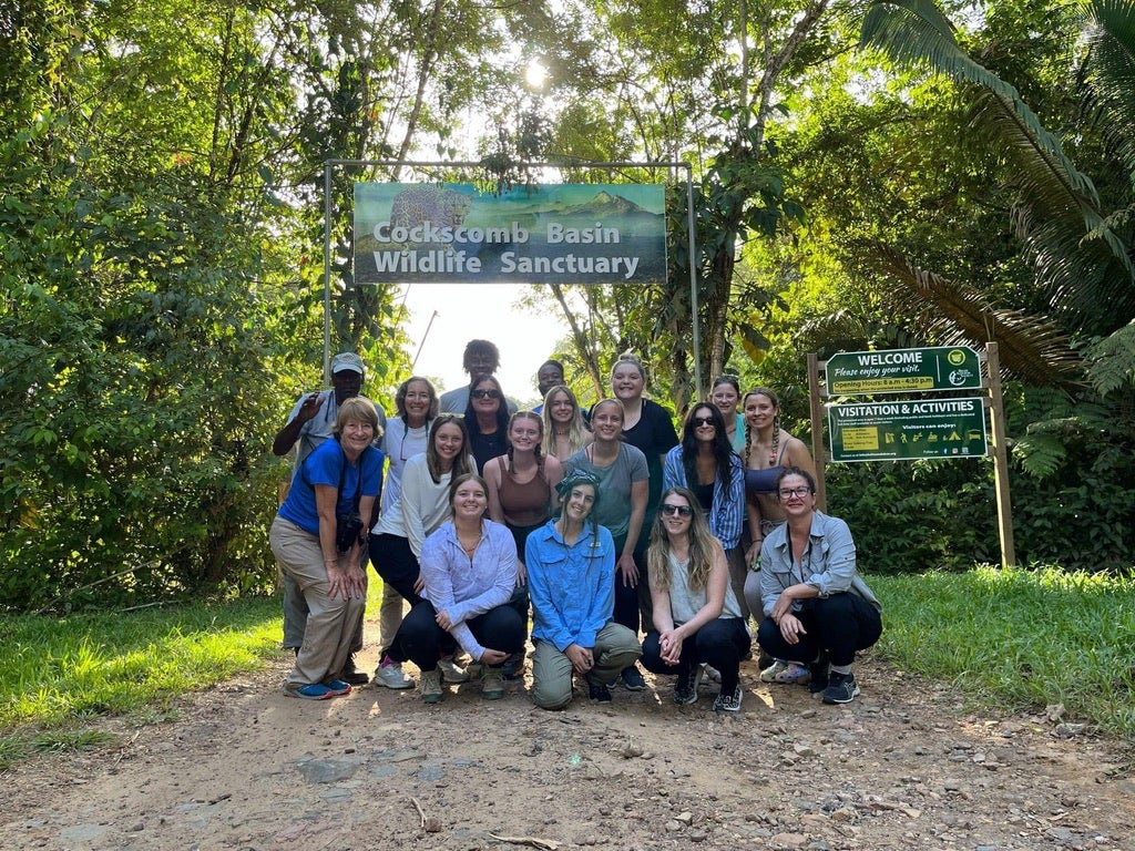 grou photo in front of welcome sign to wildlife sanctuary in Belize