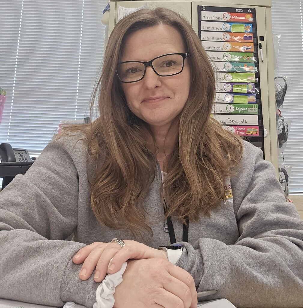 woman sitting at her desk in classroom