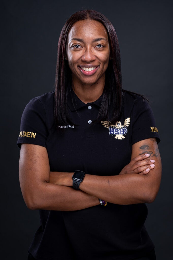 professional photo of a woman with her arms crossed and smiling