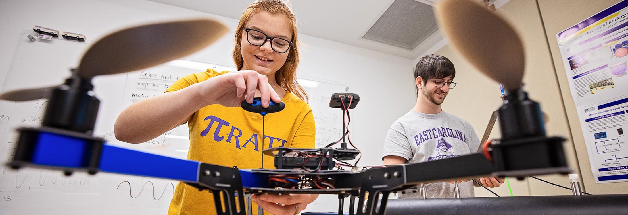 female student working on helicopter robot